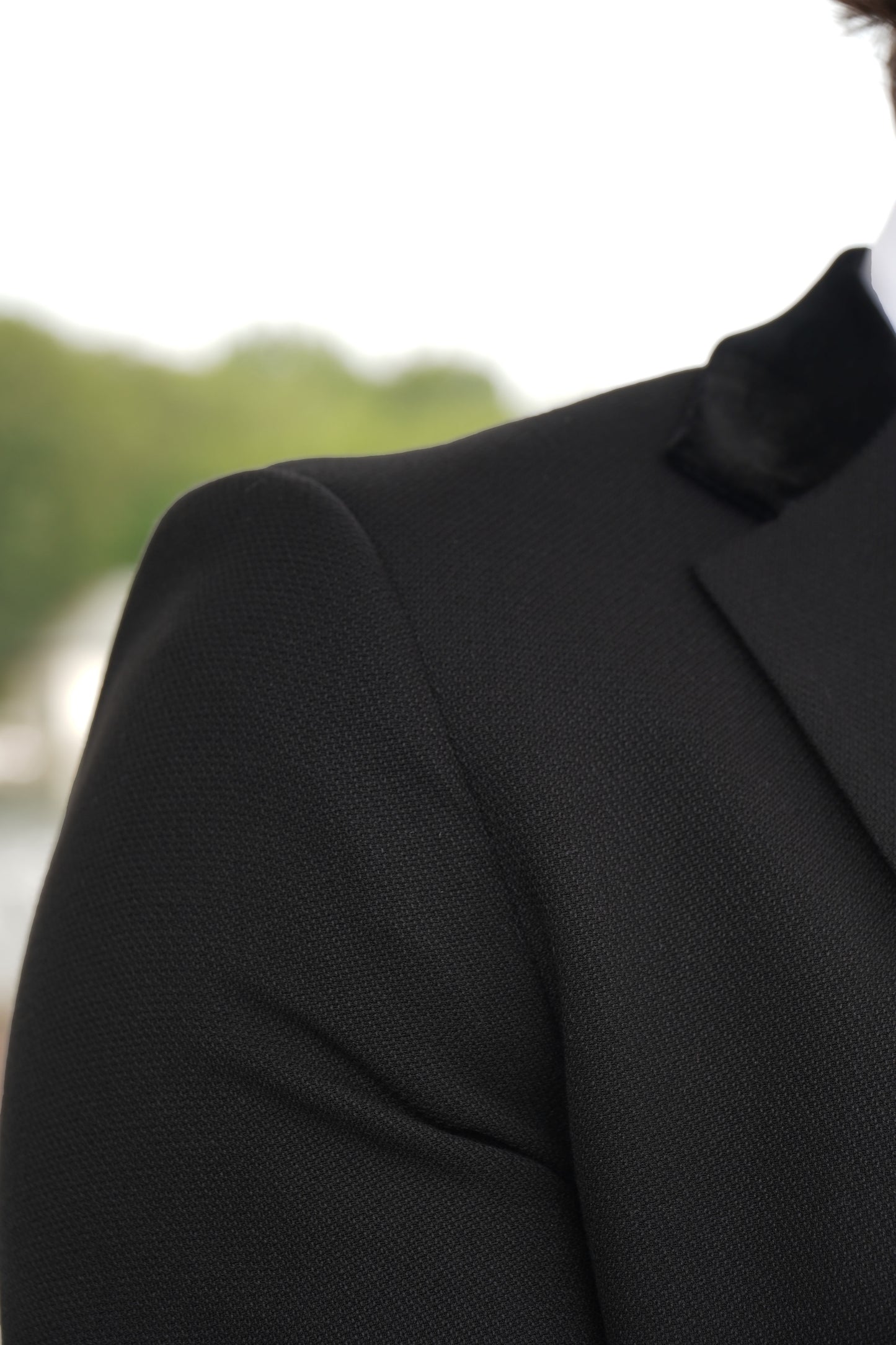 Close-up of the SUITBAE Majid Textured Three-Piece Suit — showcasing the premium black textured fabric and smooth velvet collar detailing, crafted for weddings, proms and formal events.