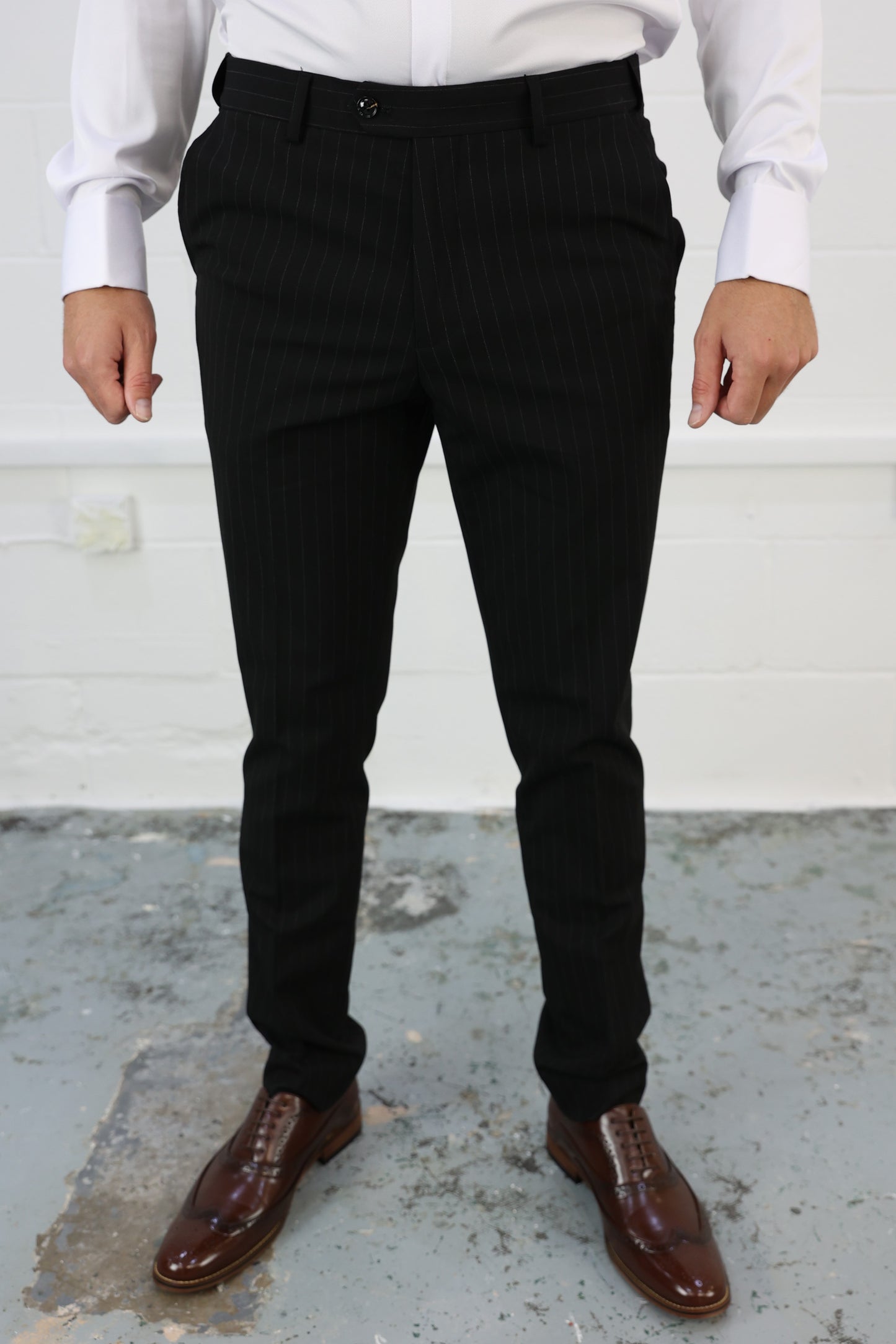 Front view of Suitbae black pinstripe slim tailored fit tapered trousers, featuring a modern design with an elastic waistband for enhanced comfort; sold individually, perfect for formal or smart-casual wear.