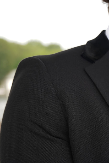 Close-up of the SUITBAE Majid Textured Three-Piece Suit — showcasing the premium black textured fabric and smooth velvet collar detailing, crafted for weddings, proms and formal events.