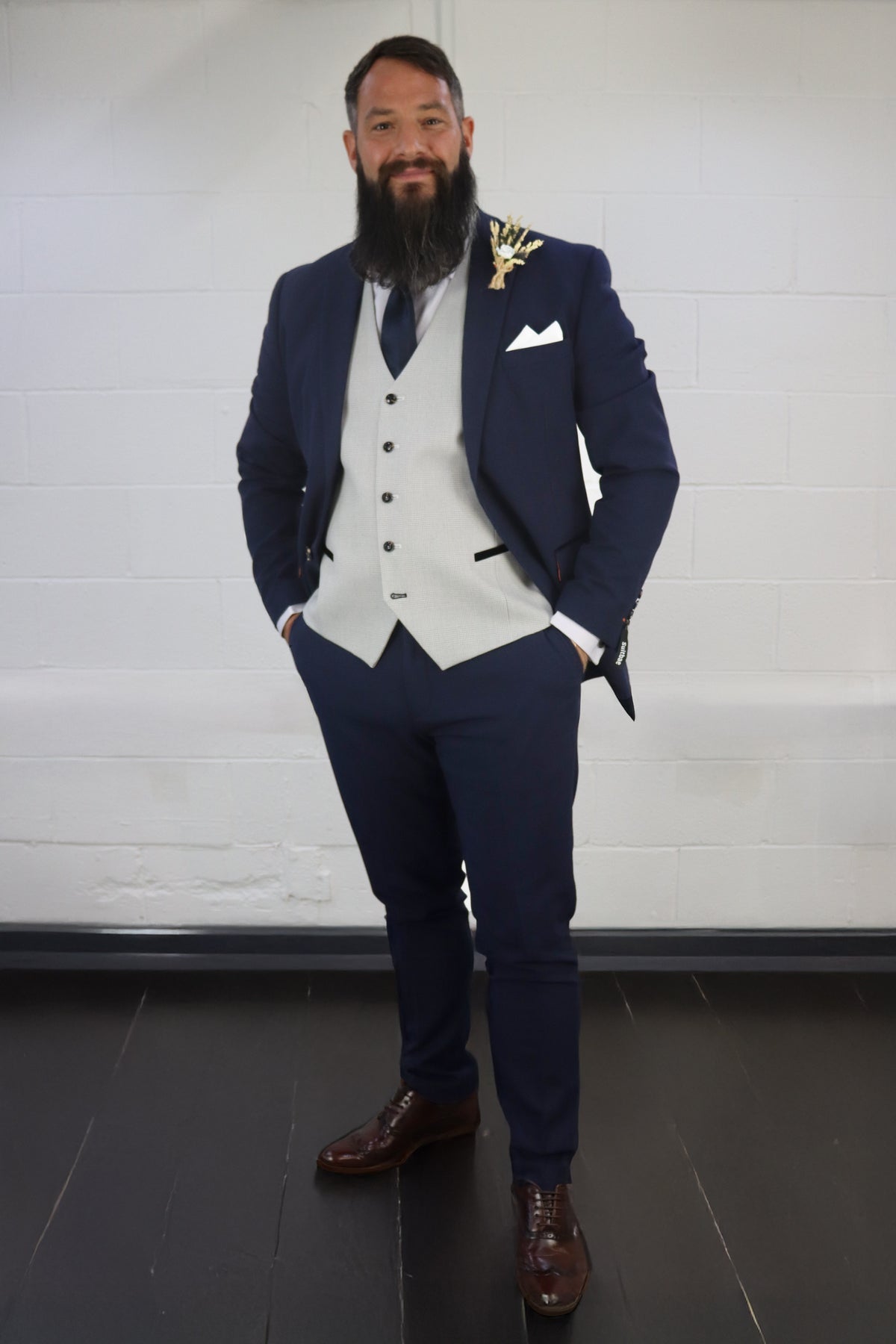 Model wearing the SUITBAE Charles Navy with Contrast Stone Waistcoat Three Piece Suit — navy slim-fit blazer, stone patterned waistcoat with black trim, navy trousers, and brown brogues — perfect for weddings, proms, and race days — available at SUITBAE Blackpool, Barnsley and shpxlxnx.top.