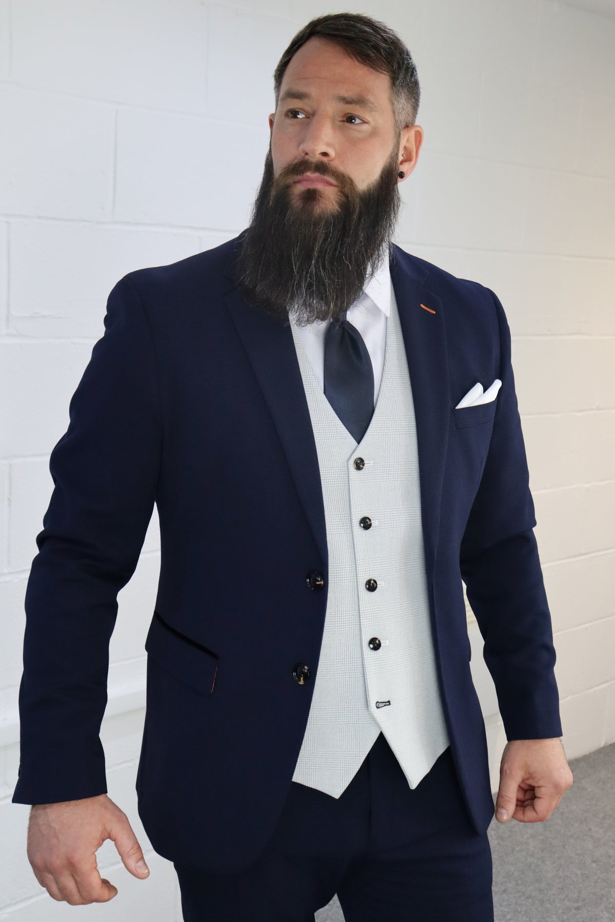 Model wearing the SUITBAE Charles Navy with Contrast Stone Waistcoat Three Piece Suit — navy blazer with orange stitching detail, light stone waistcoat, navy tie, and white pocket square — a standout choice for grooms, weddings, or formal events — available at SUITBAE Blackpool, Barnsley and shpxlxnx.top.