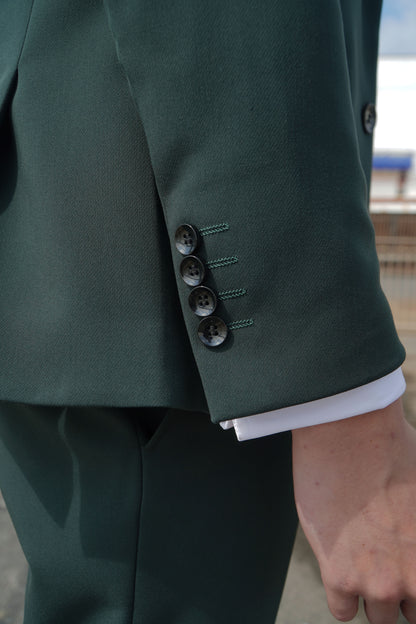 Close-up of the SUITBAE Archie Green Three-Piece Suit — showing the textured green fabric, four-button cuff detail and precise tailoring, designed for weddings, proms and formal events.