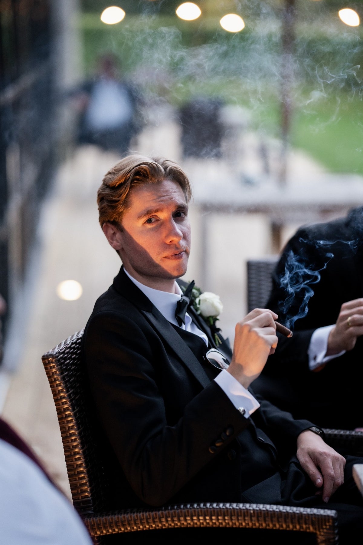 Man wearing the SUITBAE Diablo Black Tuxedo Three Piece Suit with satin lapels and waistcoat, styled for an evening wedding. Luxurious formalwear ideal for black-tie events and special occasions.